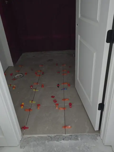 Floor tile installation with leveling clips, real Bellagio Tile & Flooring work photo 30
