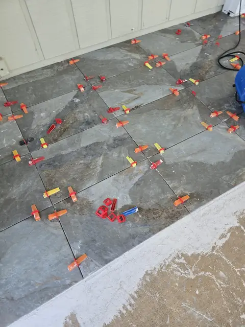 Gray floor tile installation near the window, real Bellagio Tile & Flooring work photo 37