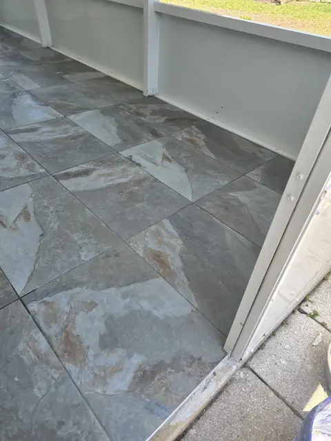 Installed gray tile flooring at the threshold, real Bellagio Tile & Flooring work photo 38