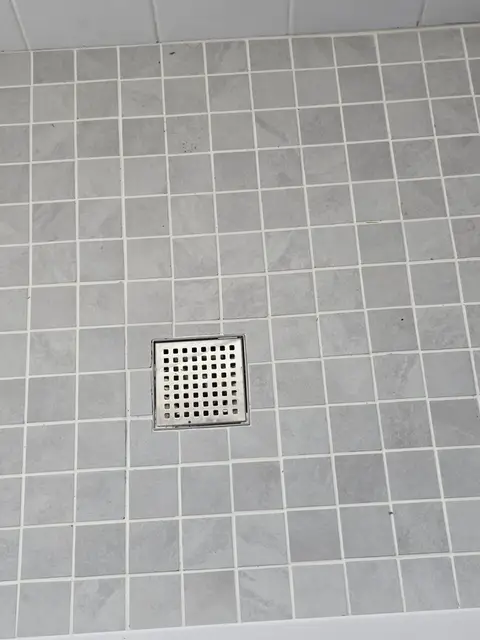Gray mosaic shower floor and drain detail, real Bellagio Tile & Flooring work photo 49